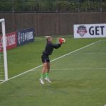 woman goalkeeper catching the ball