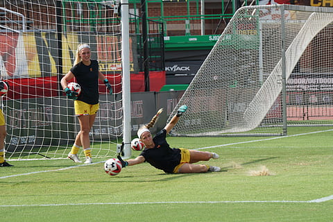Woman goalkeeper making a save in training