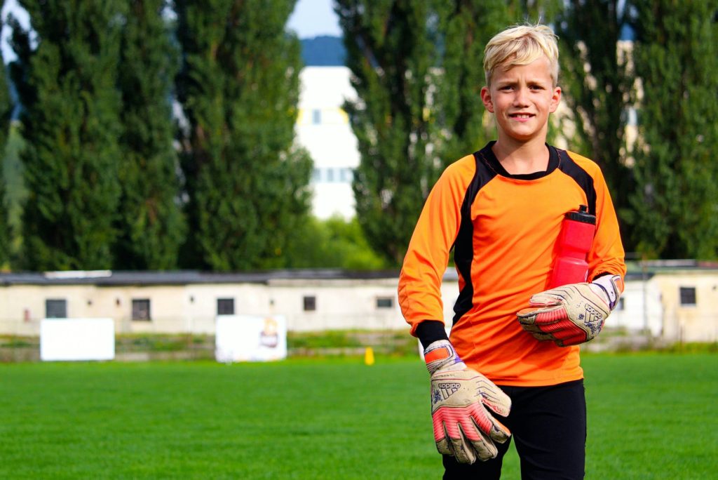 young goalkeeper with fukk ooutfit and water bottle
